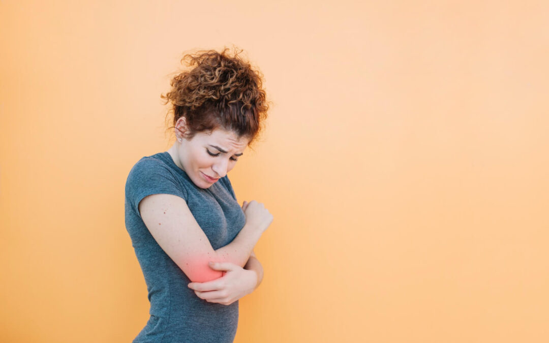 a woman in need of a tennis elbow rehabilitation exercises to ease her pain